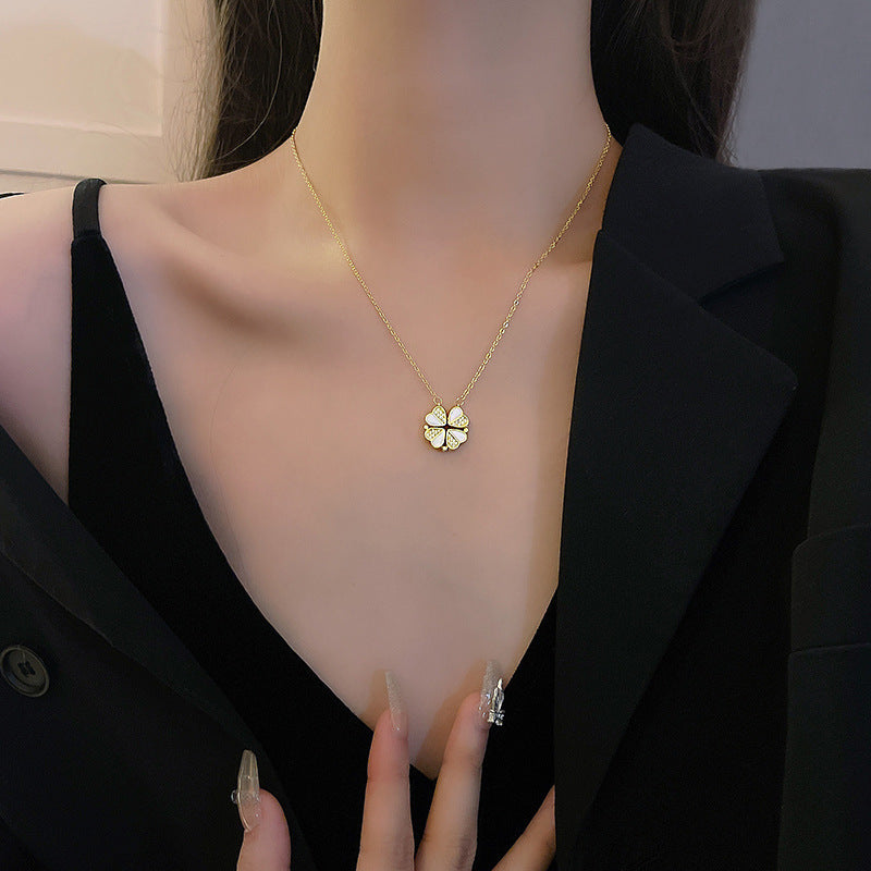 Clover necklace worn, showing the pendant and fine chain