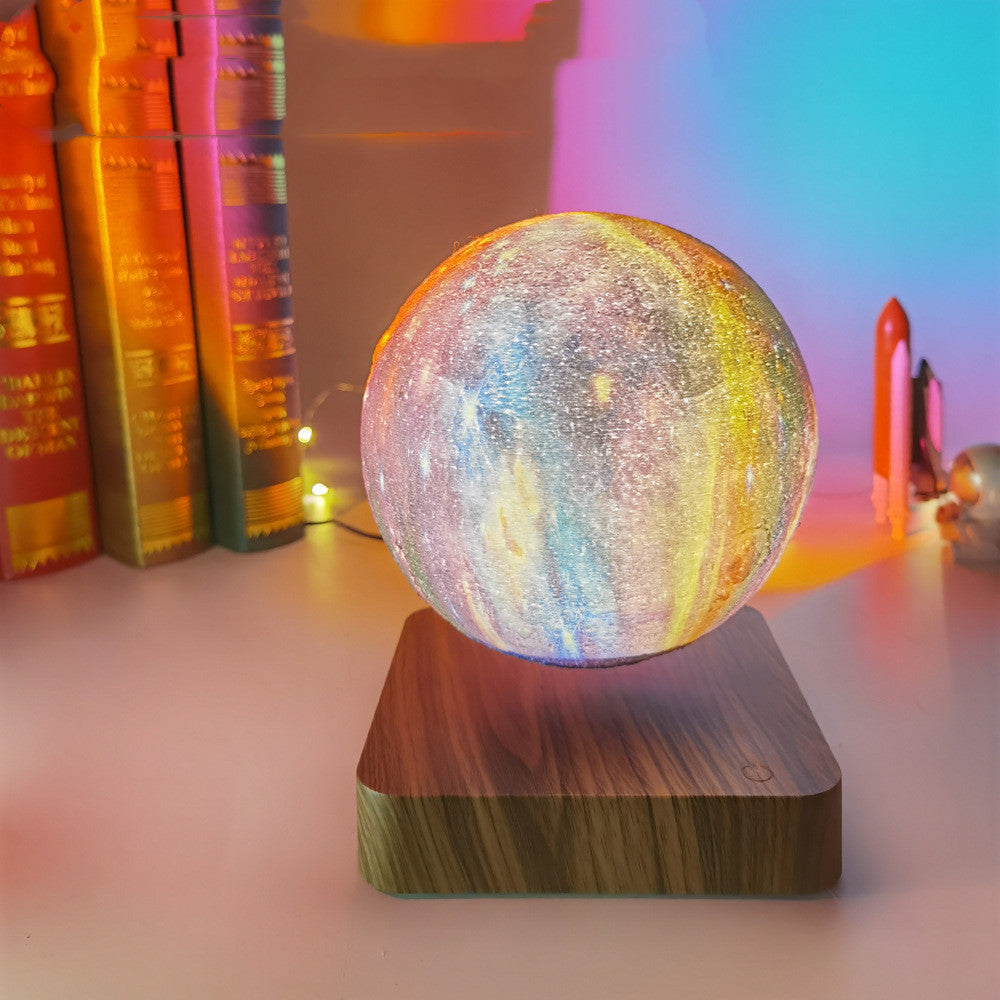 Levitating galaxy lamp floating and spinning above its magnetic base